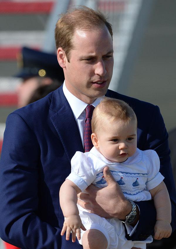 Prince william holding prince george