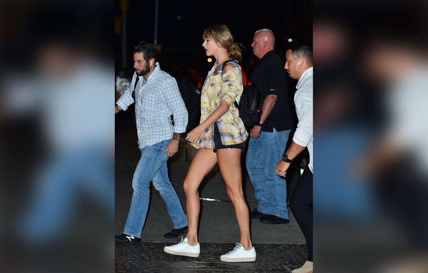 Taylor Swift is all smiles as she rocks a plaid shirt while leaving the studio in NYC