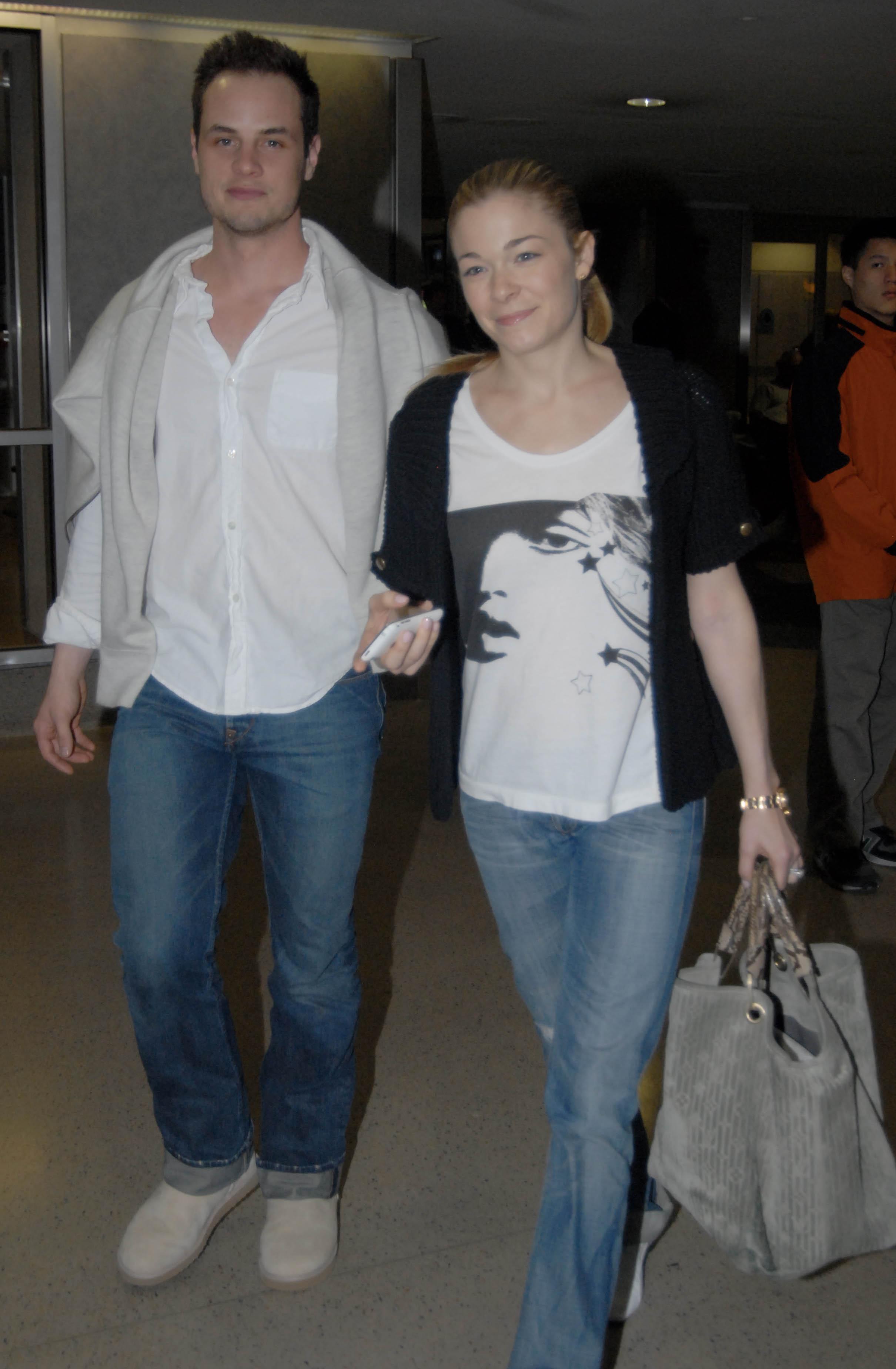 Country singer LeAnn Rimes and her husband Dean Sheremet arrive at LAX Airport in Los Angeles, CA