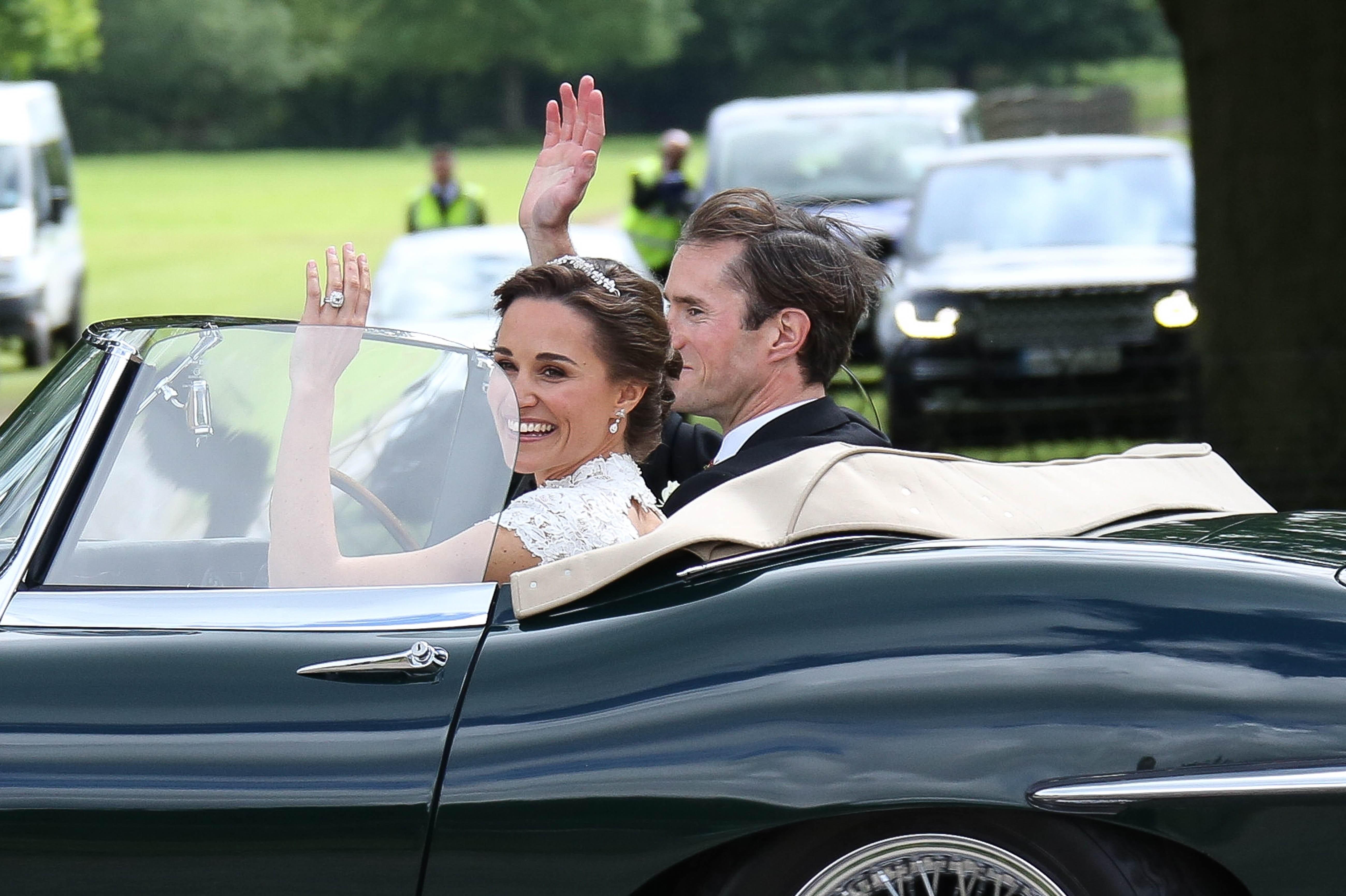 Pippa and James Matthews leave in an E type jag after their wedding ceremony