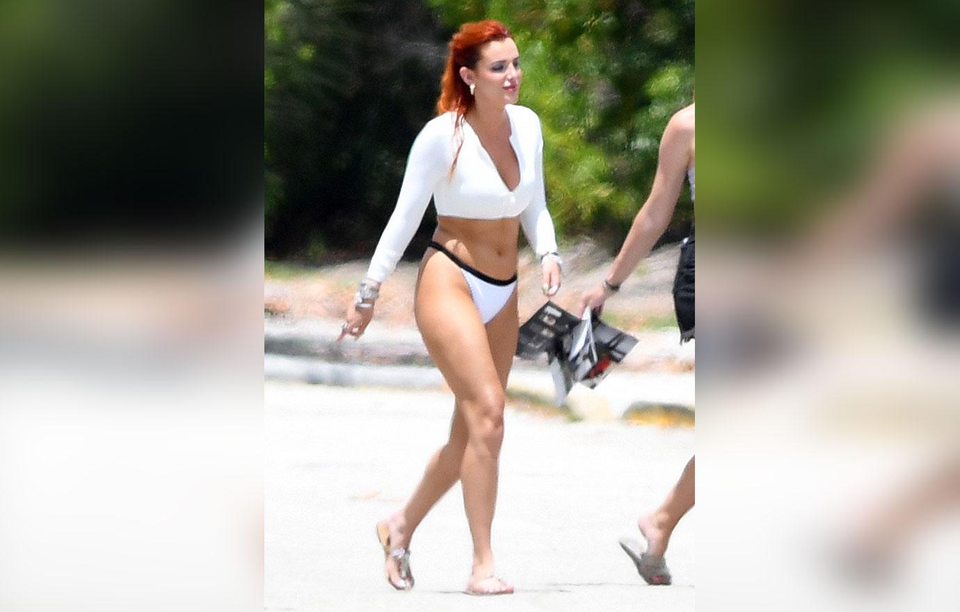 bella thorne wears yellow bikini as she poses seductively with a water hose during a photoshoot in miami ok