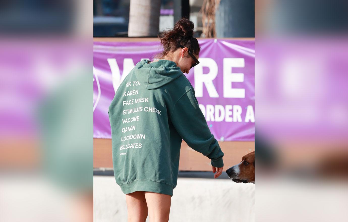 Cara Santana rocks a “see you in ‘21” Hoodie as she grabs an iced coffee after the gym. The top Made by Thirty Seconds of Mars