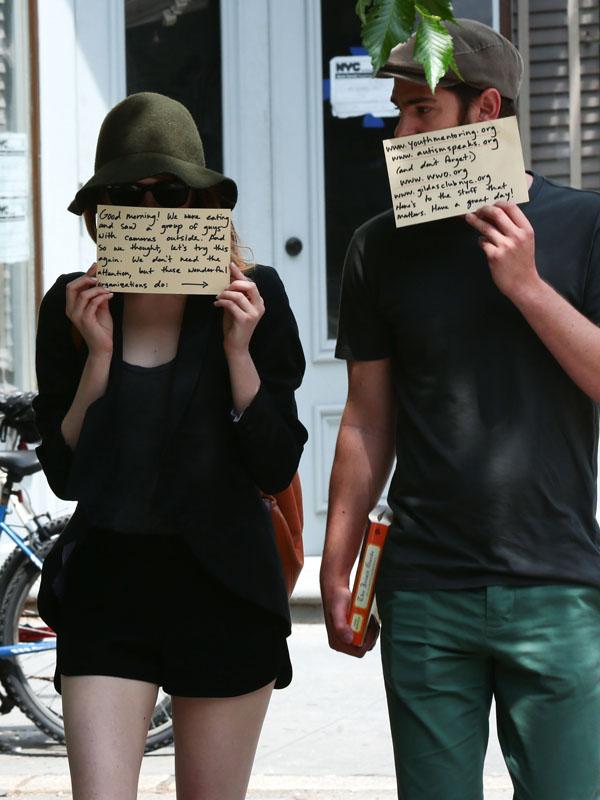 Emma Stone and Andrew Garfield covered faces of cardboard paper