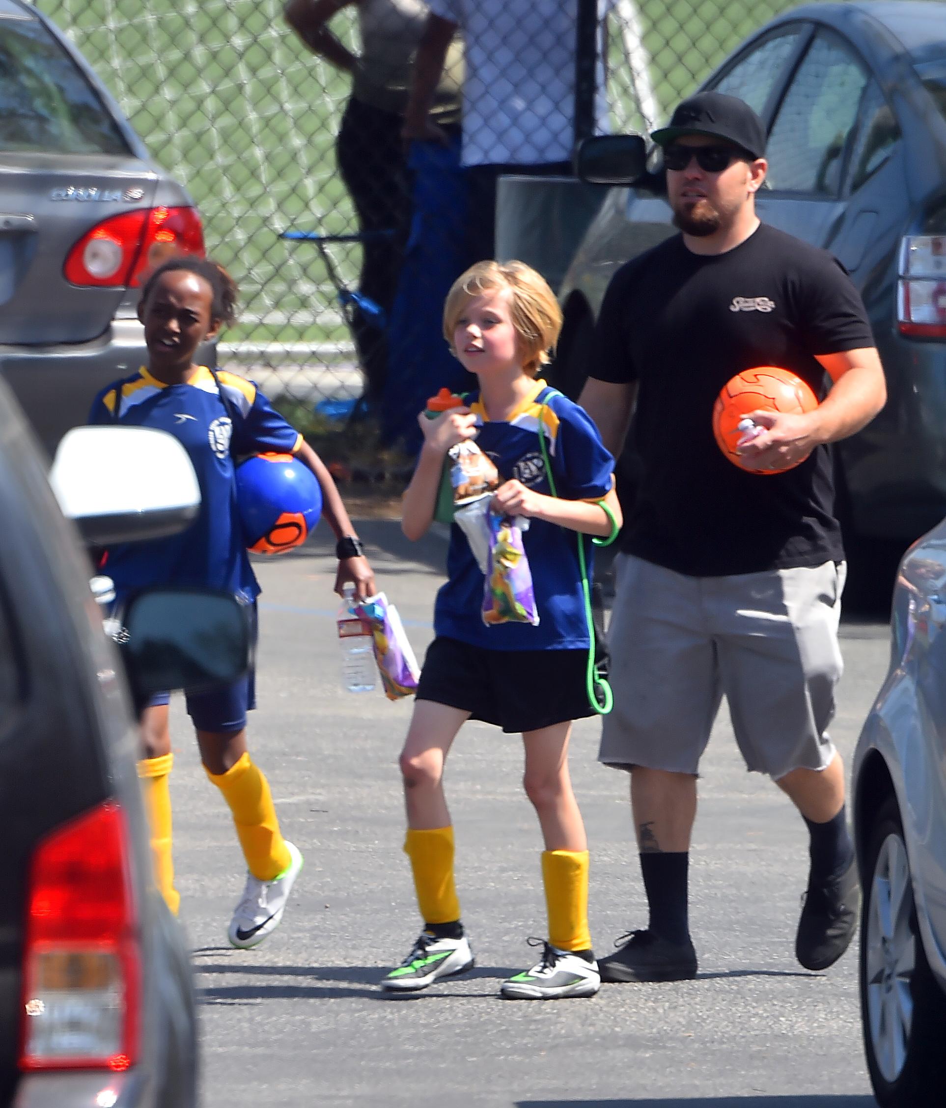 Shiloh and Zahara Jolie Pitt are accompanied by a bodygaurd to their Soccer Game in Studio City