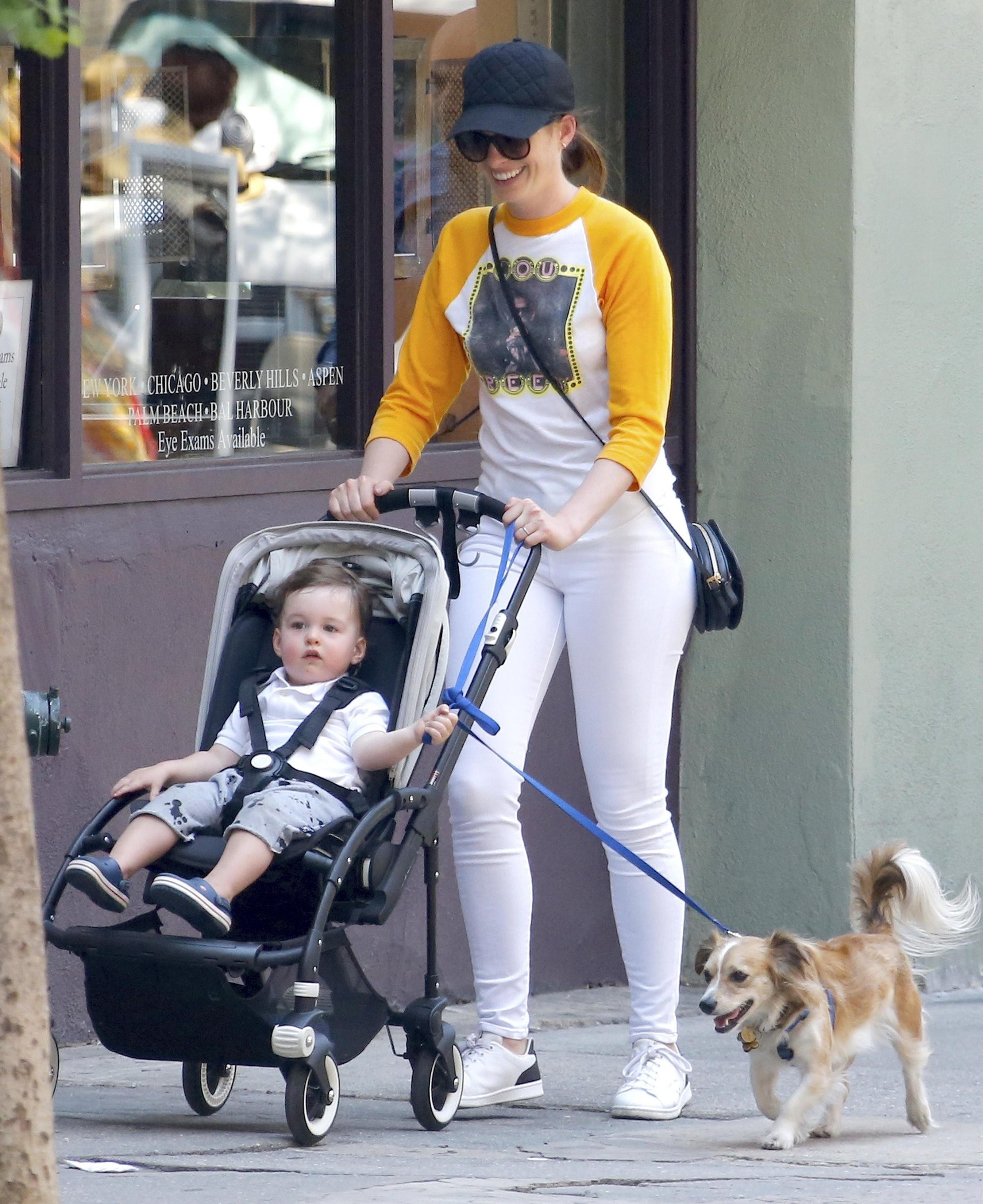 Anne Hathaway and little Jonathan take their pooch for a stroll