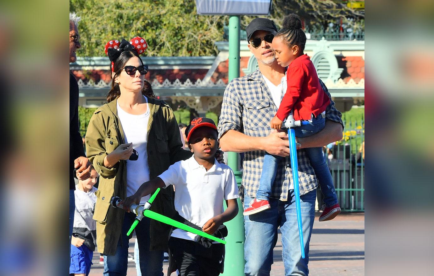 EXCLUSIVE: Sandra Bullock and her boyfriend Bryan Randall are joined by Jason Bateman and his family while spending the day at Disneyland