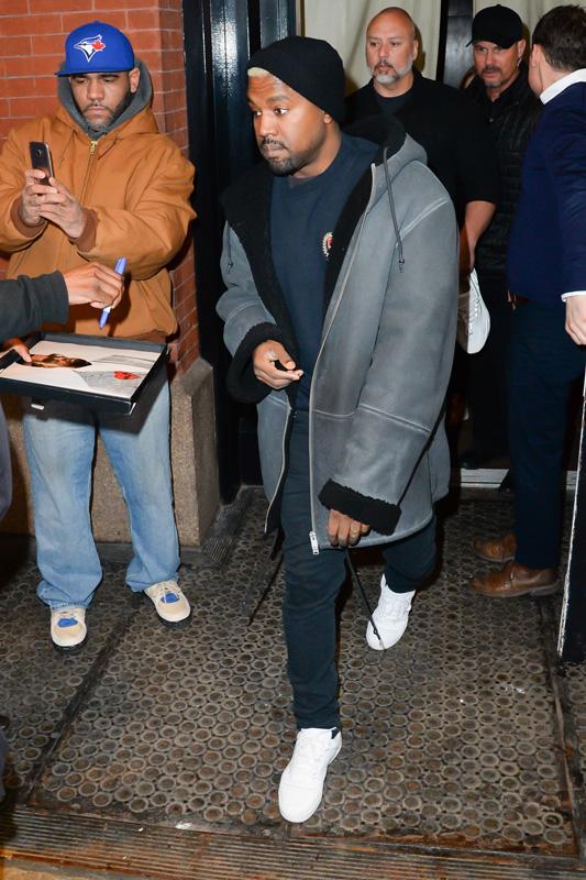 Kanye West steps out of his apartment before his fashion show starts