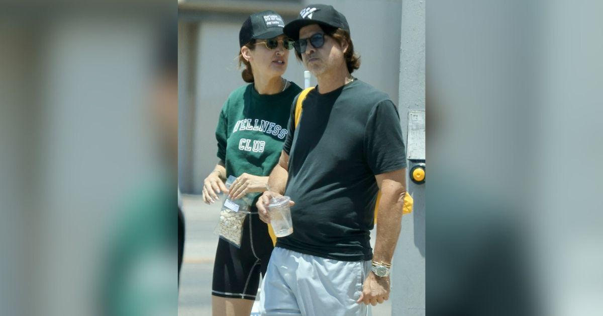 image of Rodger Berman was photographed with a mystery woman in July. 