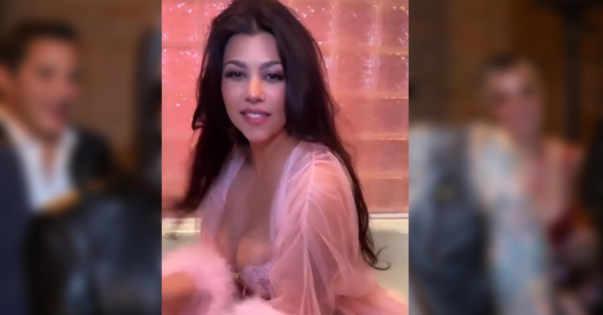 kourtney kardashian nearly spills out pink robe watch