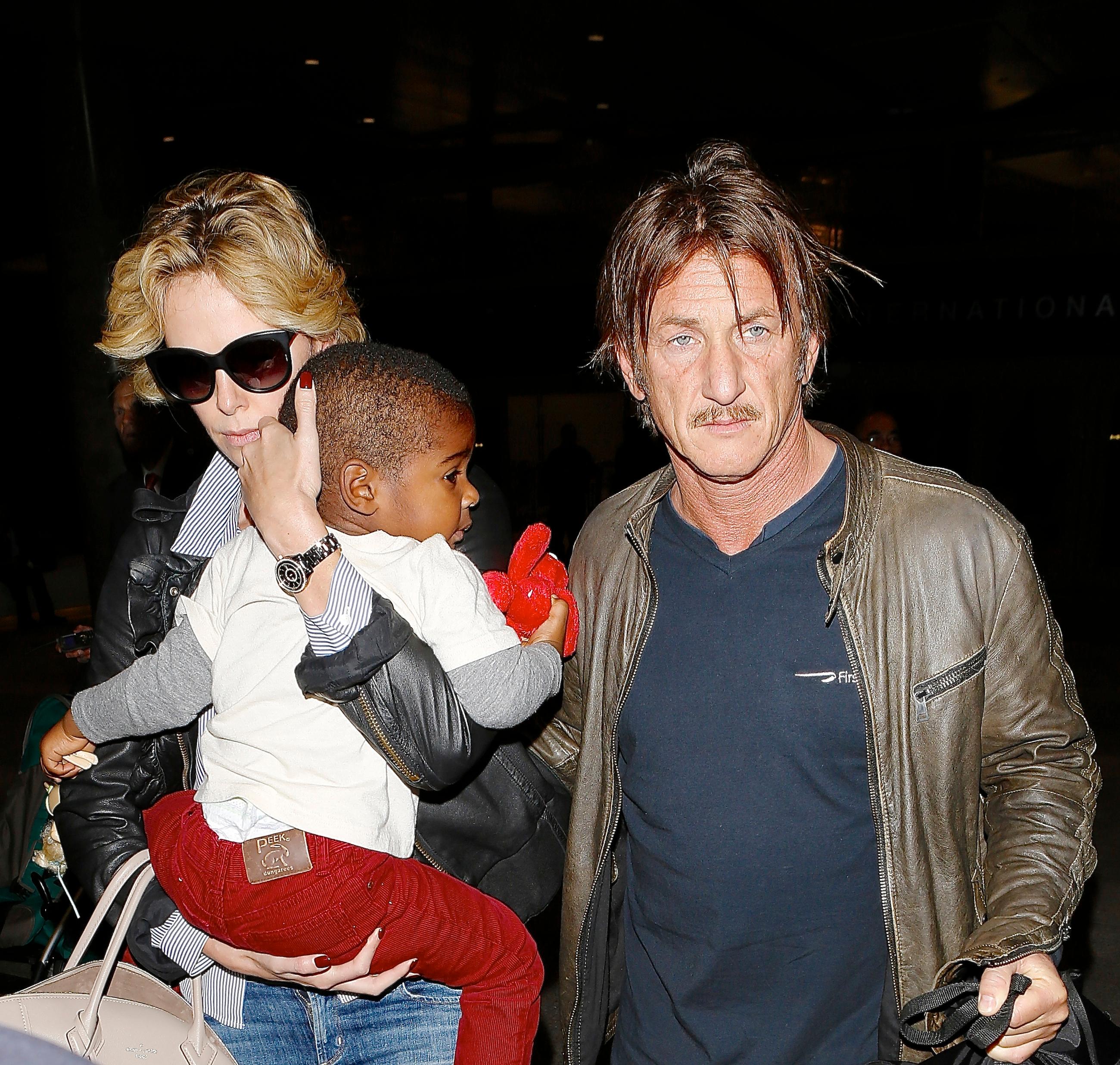 Sean Penn and Charlize Theron were seen arriving at Lax with baby Jackson