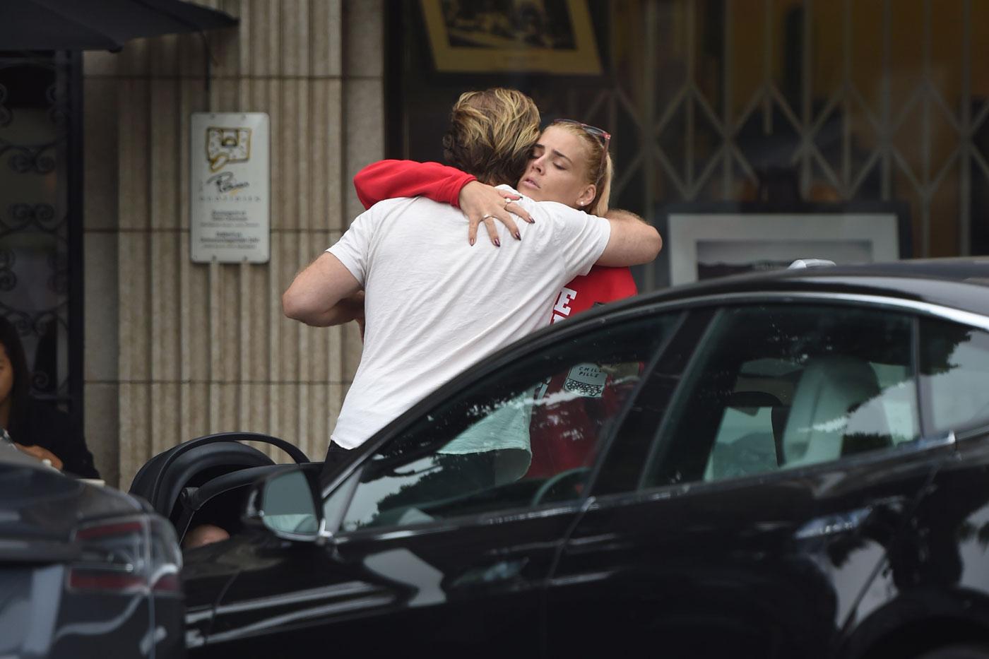 EXCLUSIVE: James Van Der Beek gives Busy Philipps a hug as they chat outside a cafe