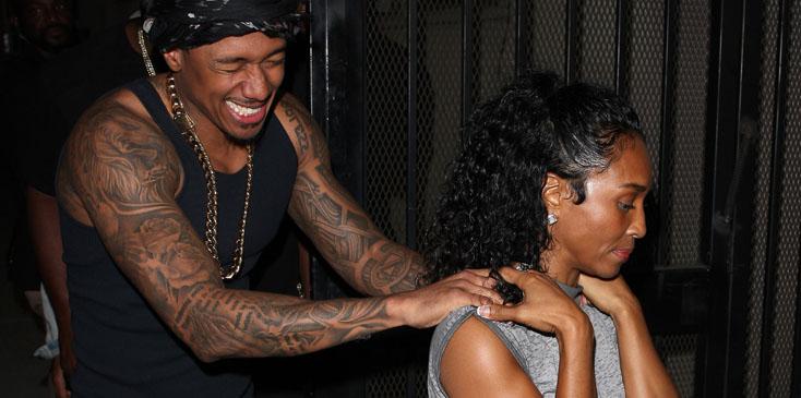 Nick Cannon puts his hands on TLC singer Rozonda Thomas&#8217; shoulders as they leave Warwick nightclub together in Hollywood