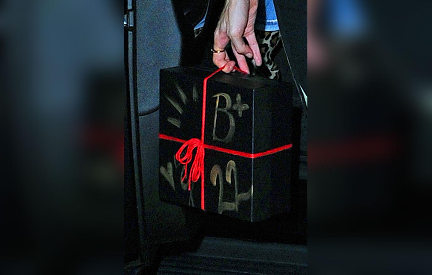 Gigi Hadid carries a present as she arrives to Bella Hadid&#8217;s birthday party