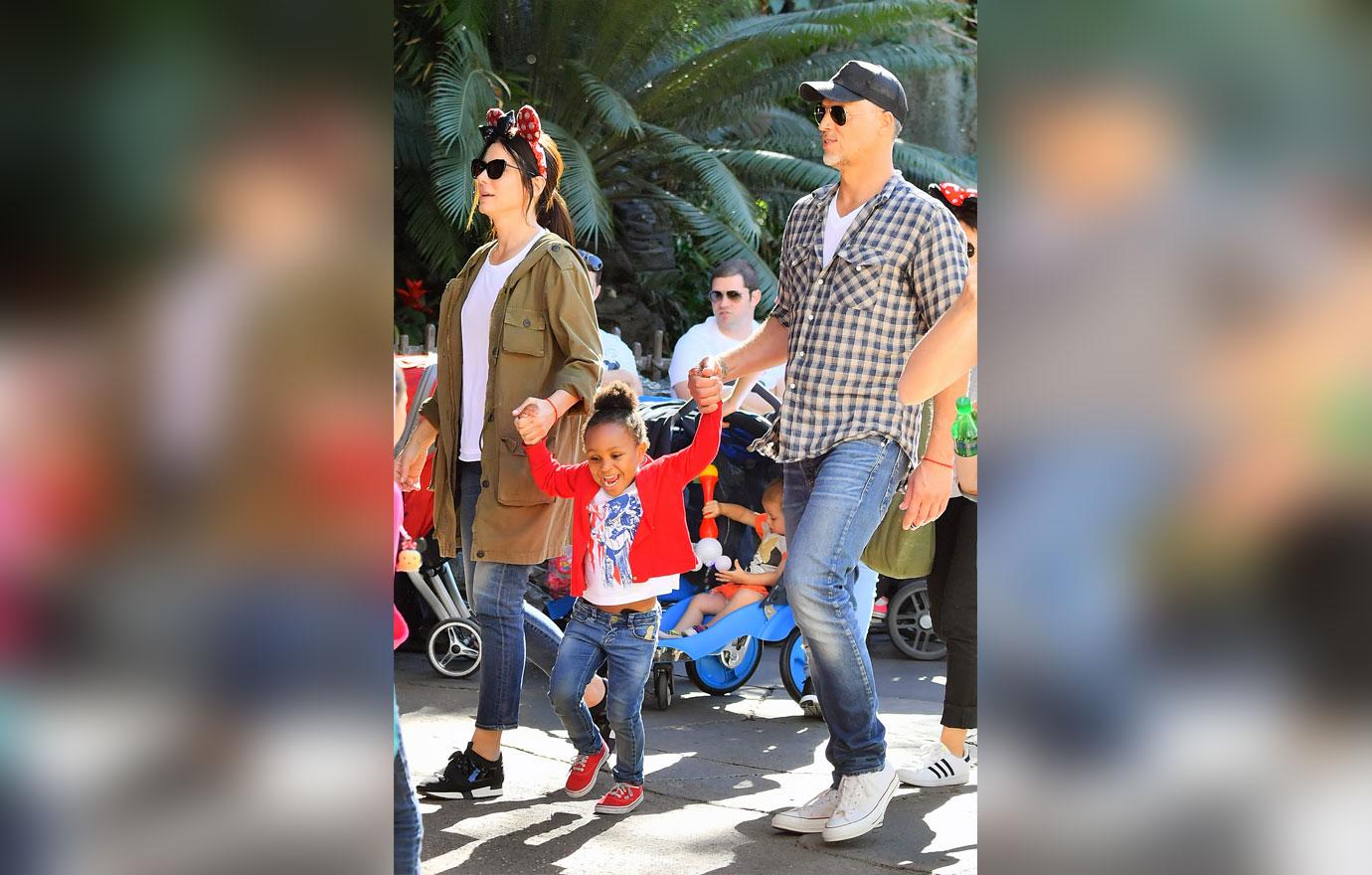 EXCLUSIVE: Sandra Bullock and her boyfriend Bryan Randall are joined by Jason Bateman and his family while spending the day at Disneyland