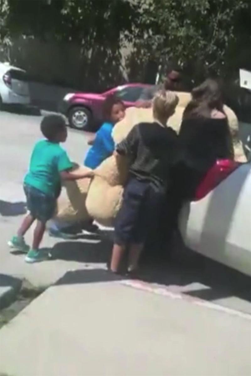 EXCLUSIVE: **PREMIUM EXCLUSIVE RATES APPLY** Angelina Jolie stops to buy an eight foot teddy bear from two children in Los Angeles, California, and struggles to squeeze it into her car