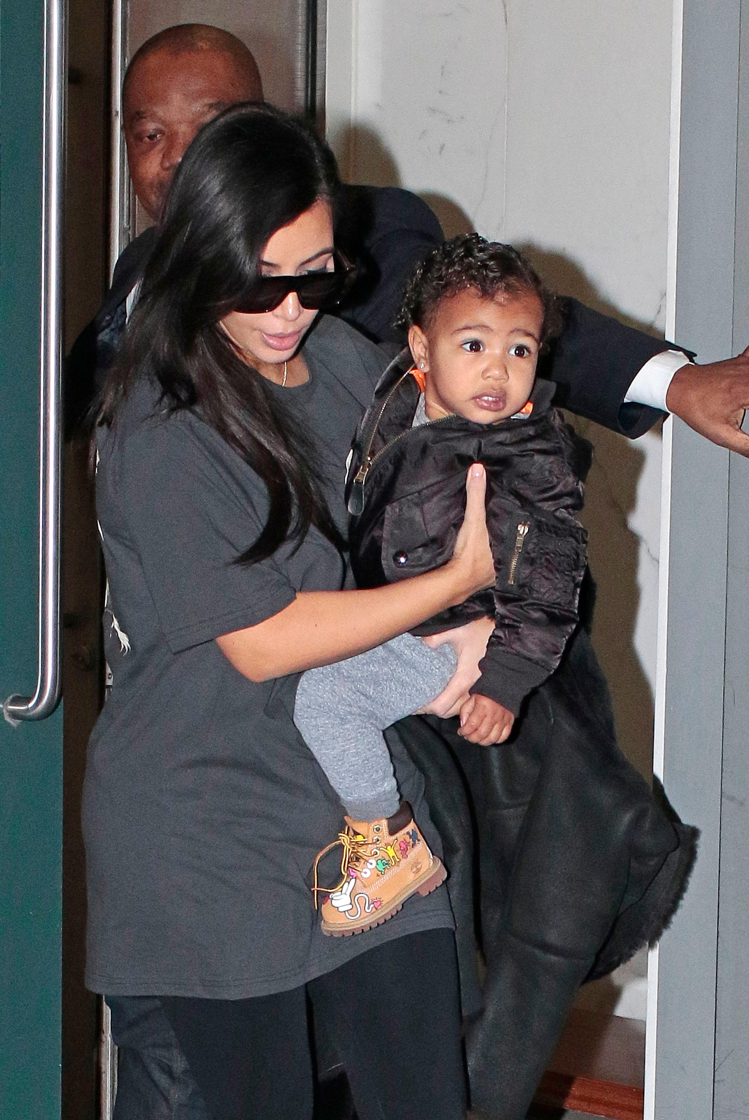 Kim Kardashian walks baby North West outside their apartment in New York City