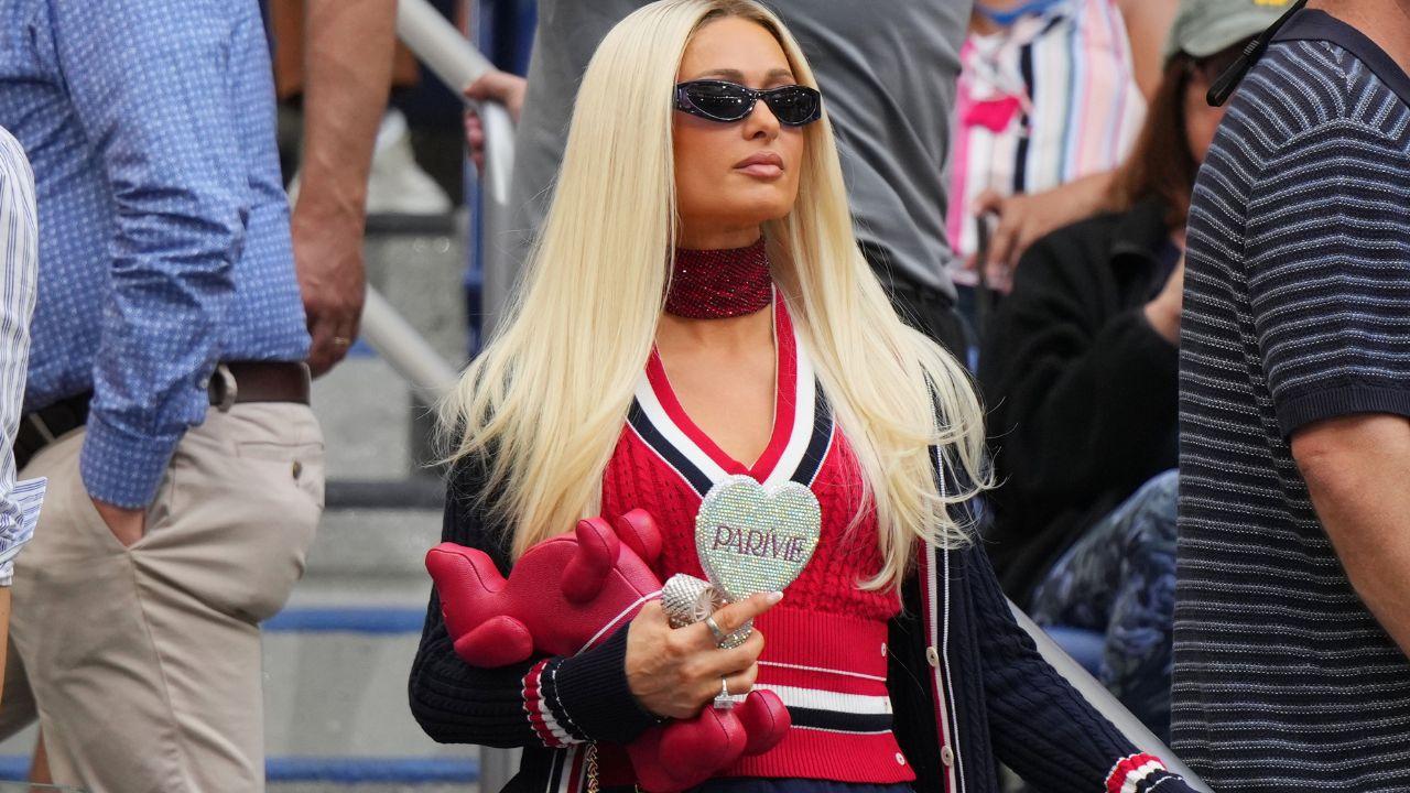 Image of Paris Hilton showed off her preppy courtside look while standing in the crowd during the match.