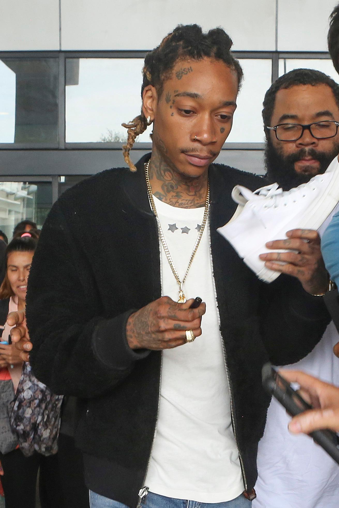 EXCLUSIVE: Wiz Khalifa keeps his head down when grilled about Kanye and Amber