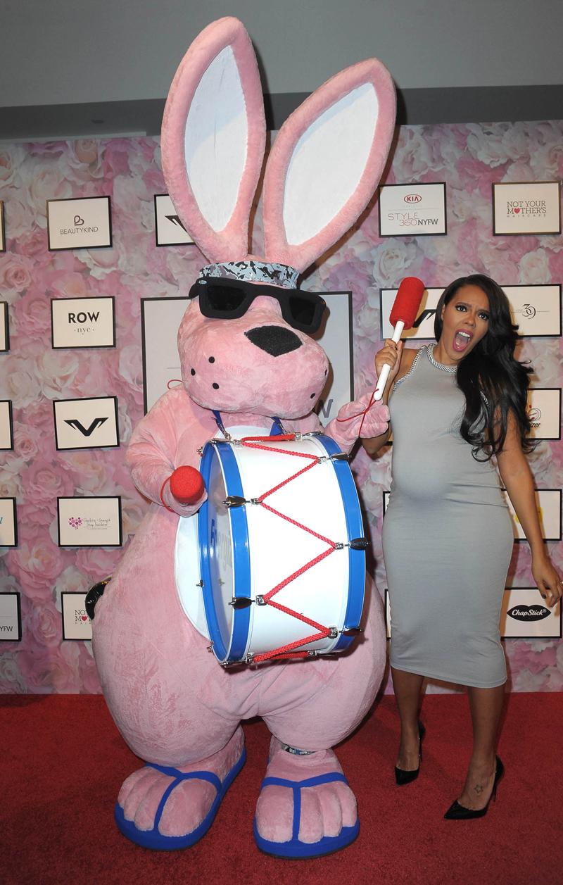 Angela Simmons poses with the Energizer Bunny during her fashion show at New York Fashion Week