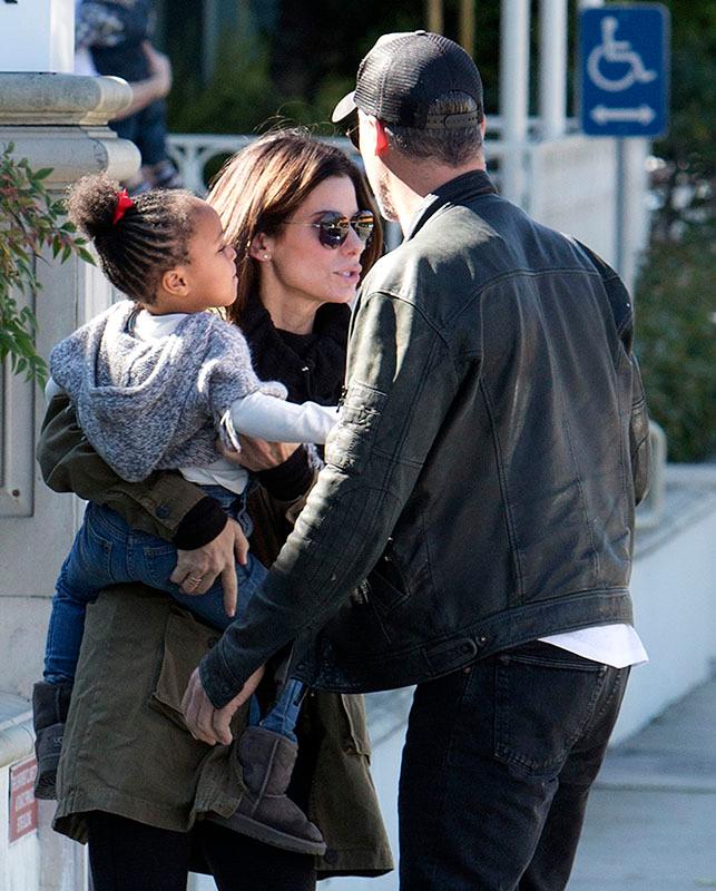 EXCLUSIVE: *** Premium Exclusive Rates Apply*** Sandra Bullock doesn&#8217;t look to impressed with boyfriend Bryan Randall as she holds her daughter Laila while they pick up coffee in Studio City, CA