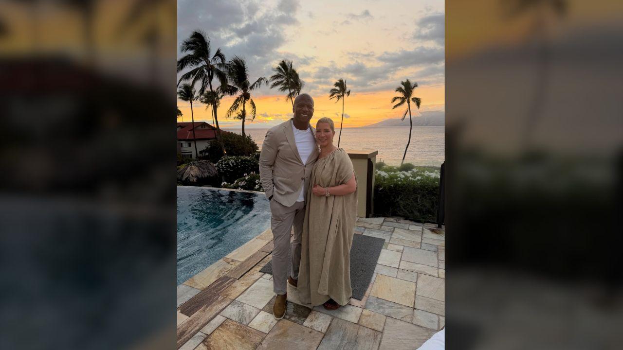 Photo of Terry Crews and Rebecca King-Crews posed in front of a gorgeous sunset.