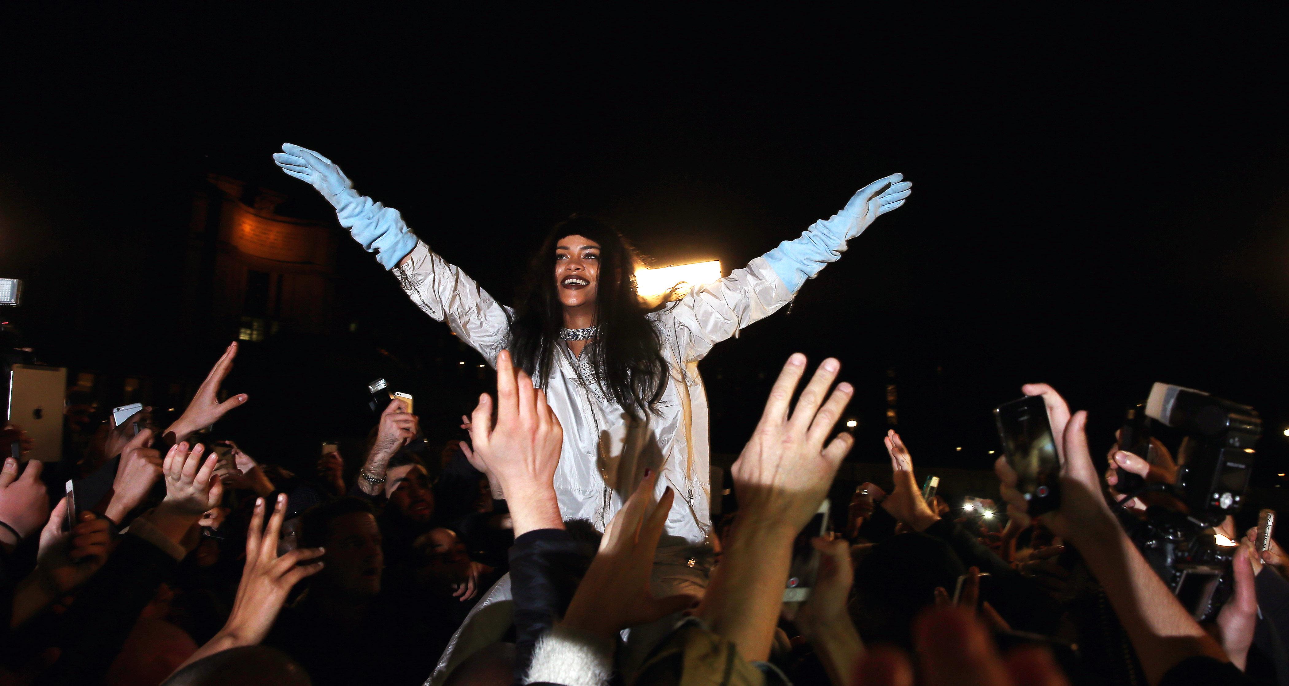 Rihanna surrounded by fans at the Trocadero park in Paris