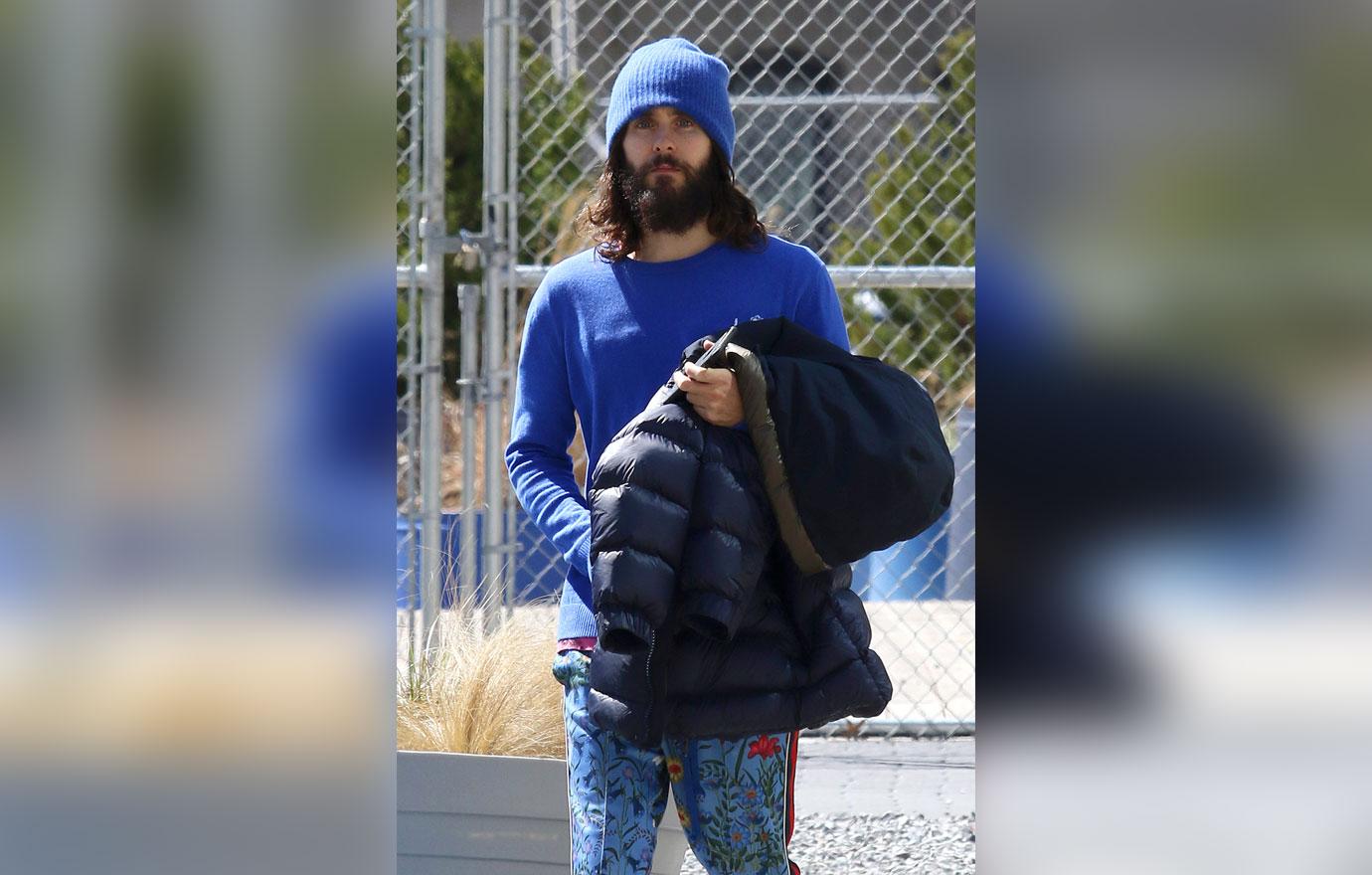 Jared Leto in blue, sports long hair and thick beard while wearing  pajama like pants in NYC