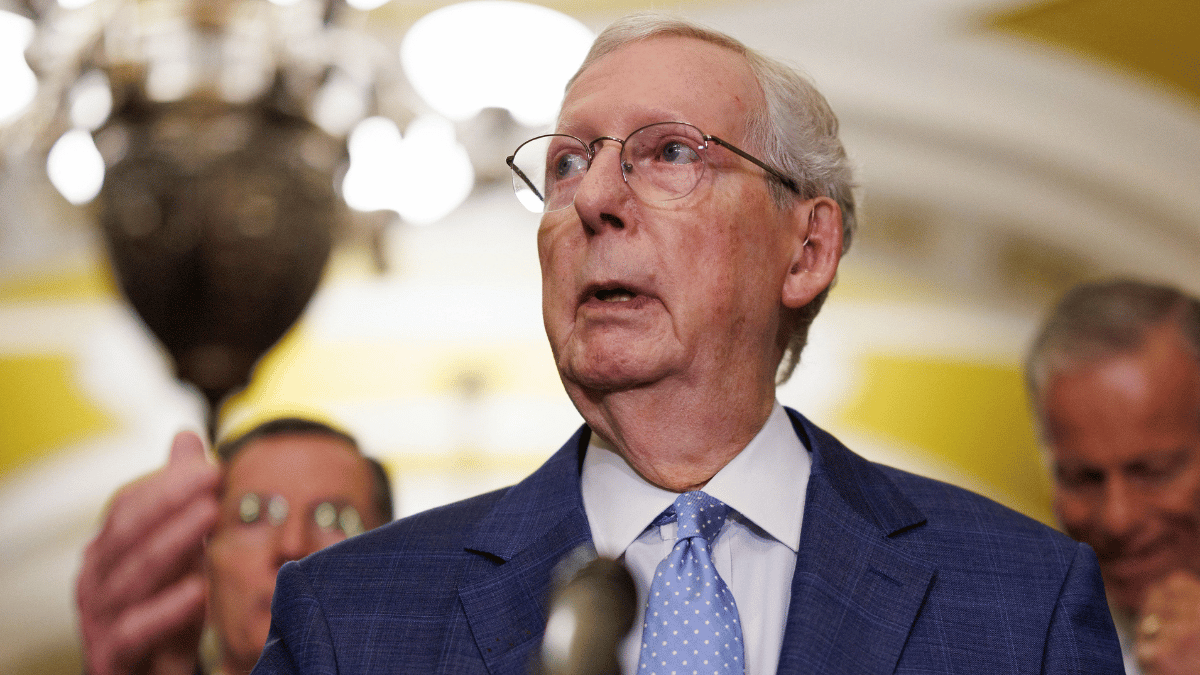 Image of Mitch McConnell's wife left a rehab center in a trench coat during a record-breaking heat wave.
