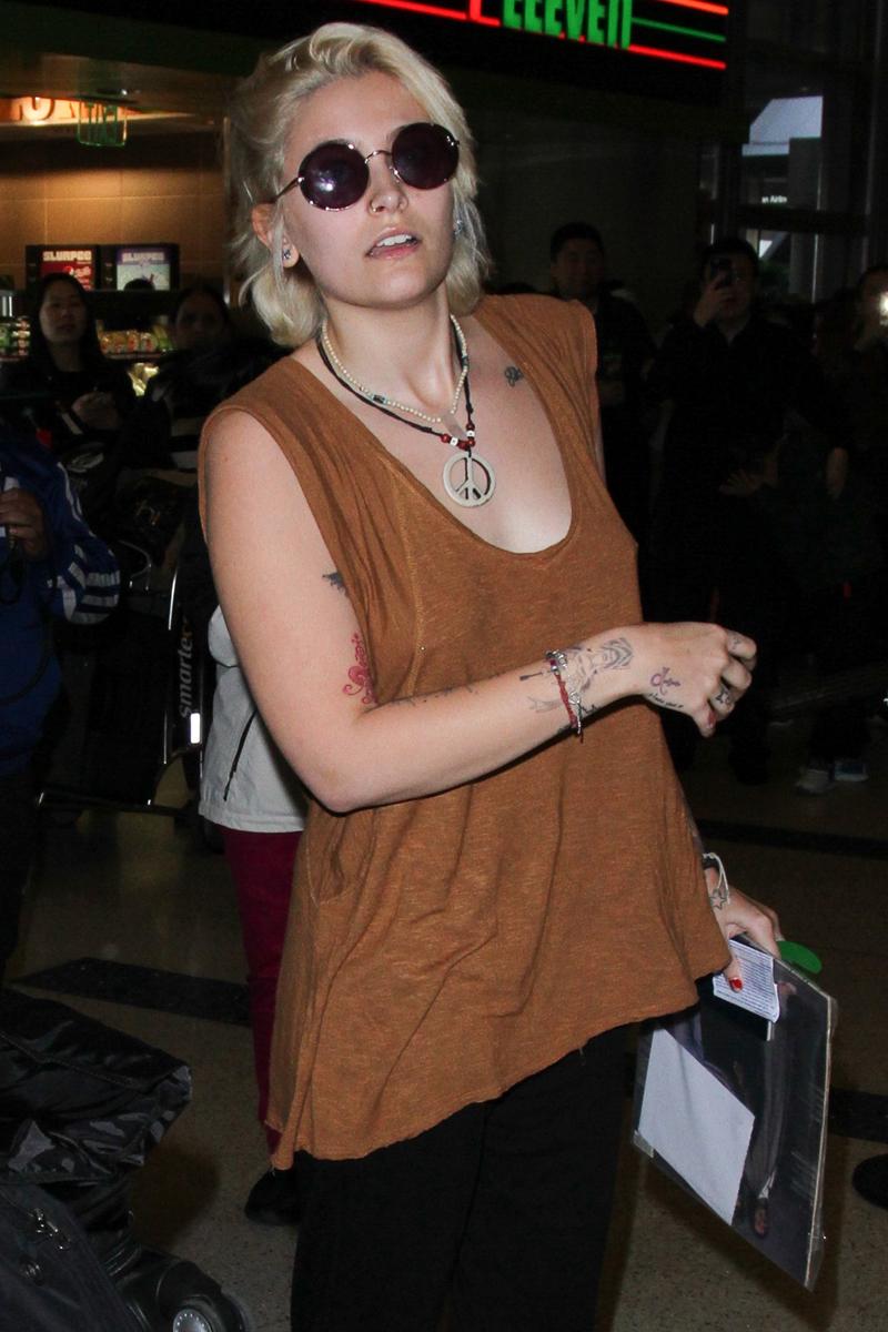 Paris Jackson gets camera shy as she arrives at LAX