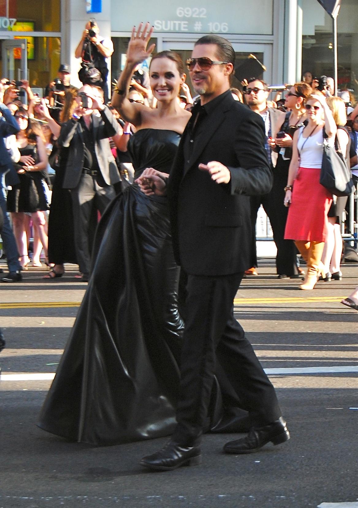 Angelina Jolie and Brad Pitt wave at fans at the &#039;Maleficent&#039; Movie Premiere