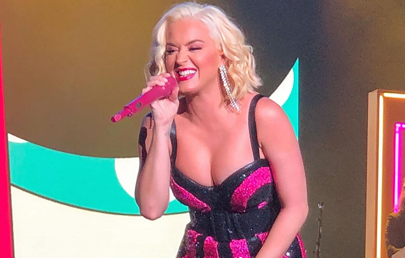 Katy Perry donned platinum blonde hair on stage as she wore a black and hot pink sparkly outfit with a low-cut top and black spaghetti straps.