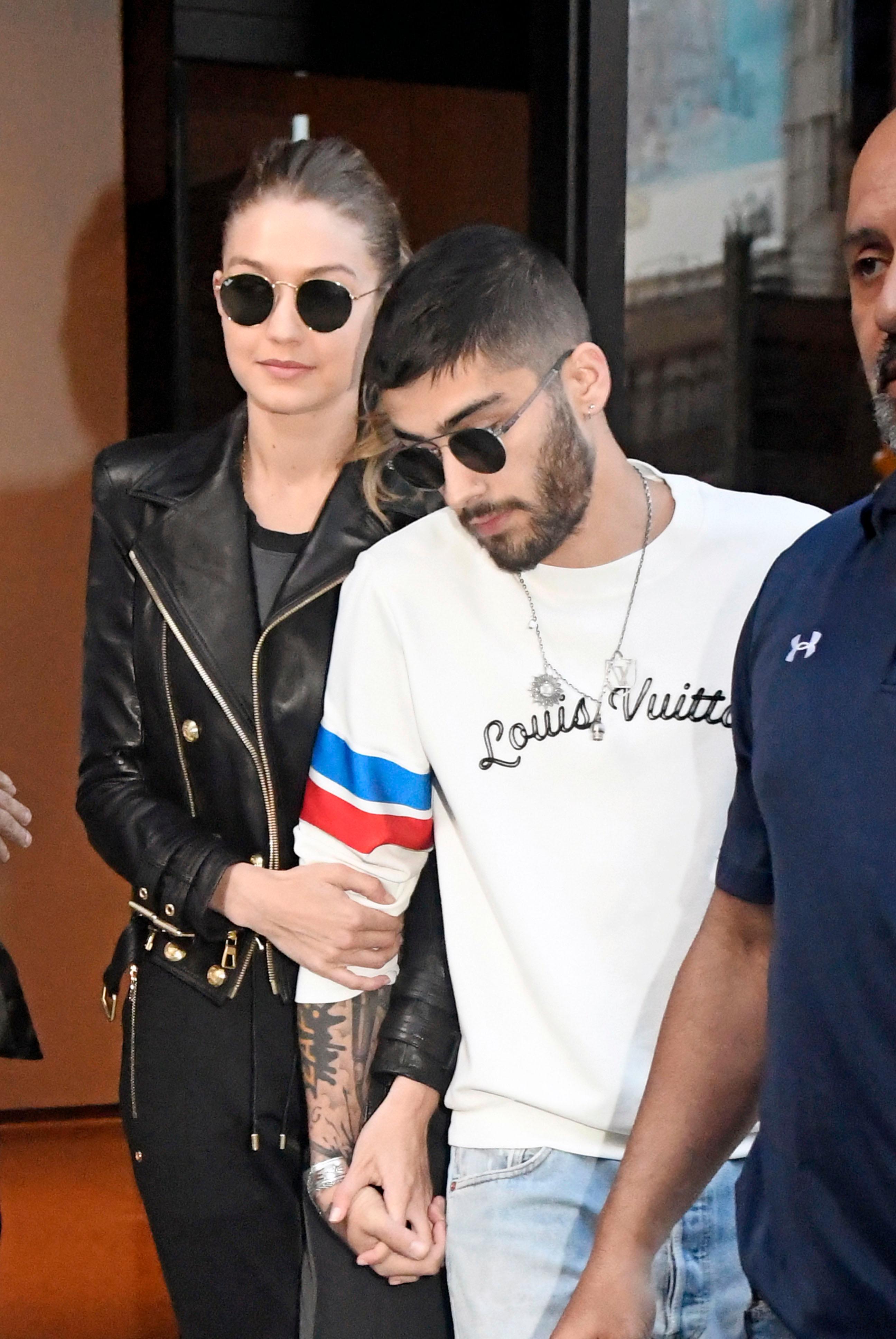 Gigi Hadid and Zayn Malik hold hands while exiting their apartment in NoHo in New York City