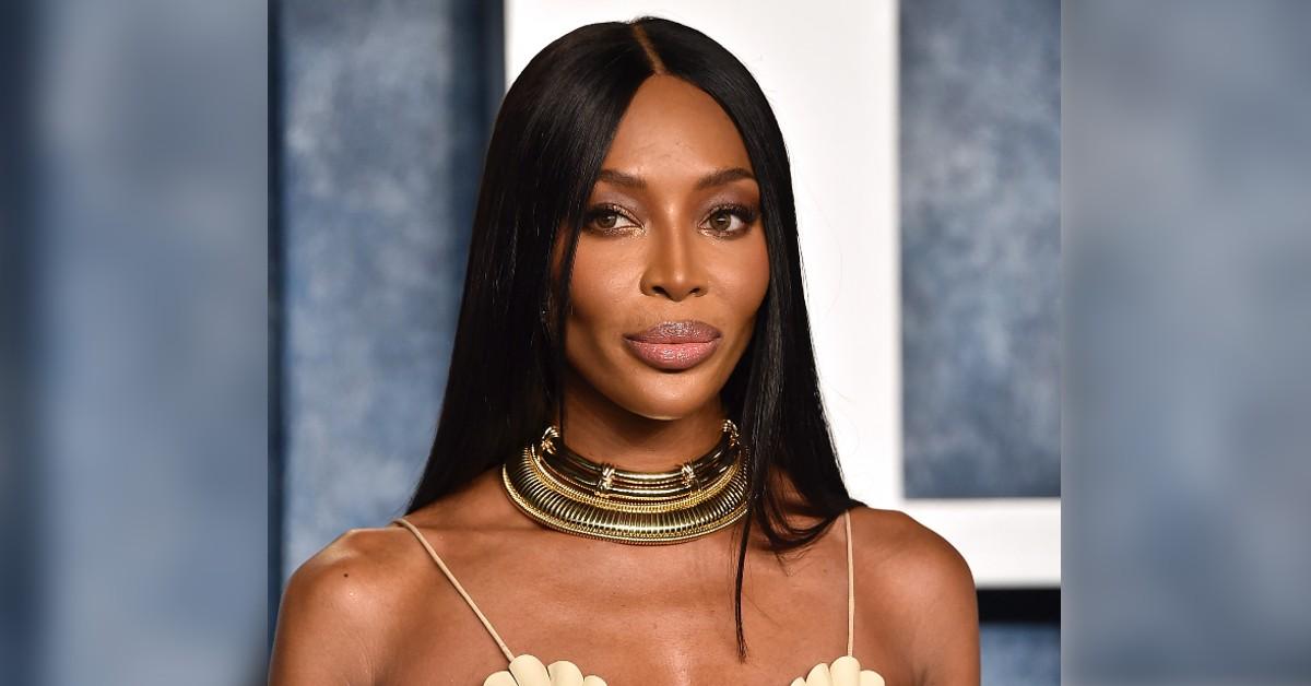 Naomi Campbell cuts a stylish figure in a white shirt and figure-hugging  corset