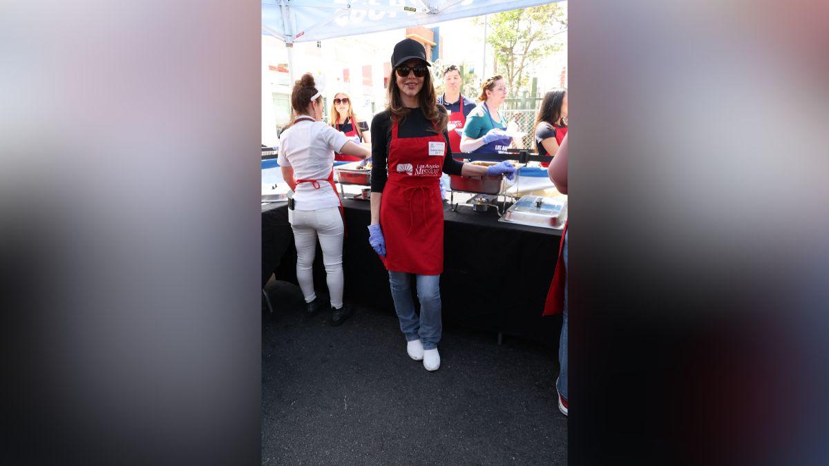 Image of Donna D'Errico served food to the homeless. 