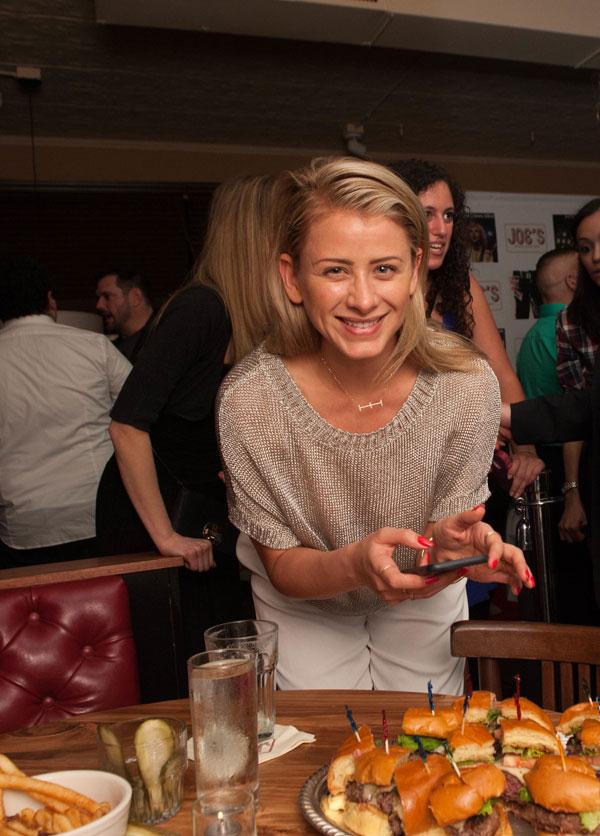 Lo Bosworth snapping a photo of the hamburgers at Grand Opening of Joe&#8217;s Bar NYC