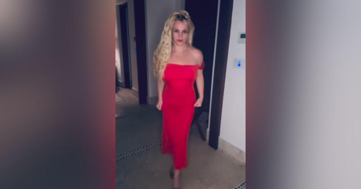 image of Britney Spears wore a red backless dress and spun around for the camera.