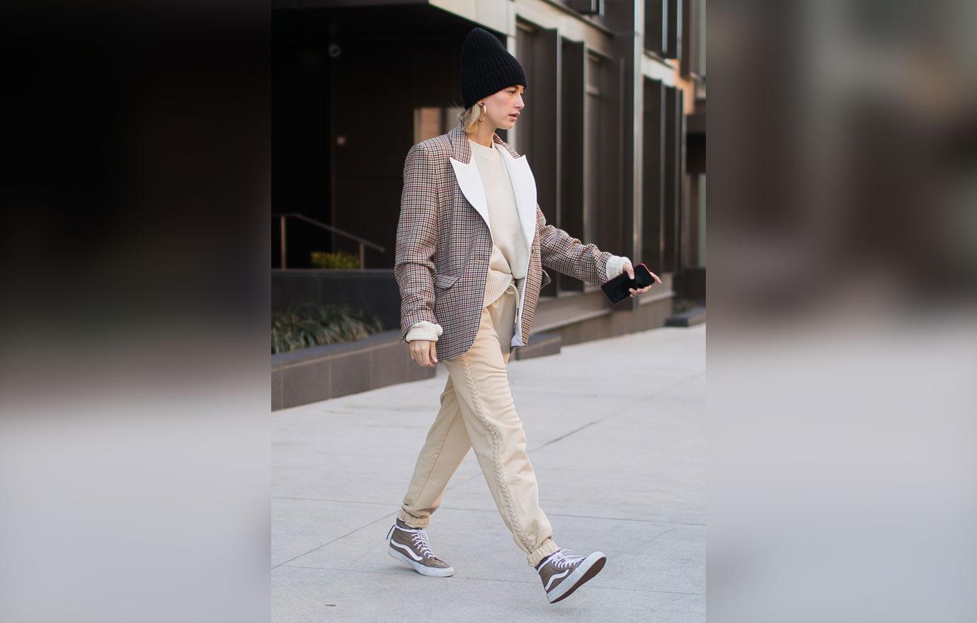 Hailey Baldwin in beige oversized jacket and black sneakers in