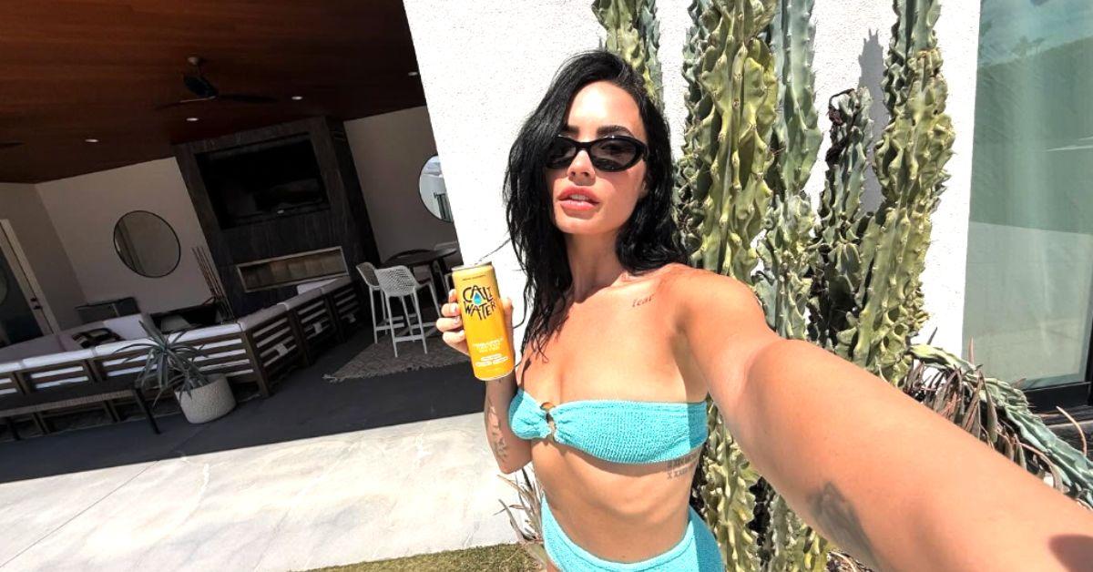 Image of Demi Lovato bared a small tattoo on her décolletage in a strapless two-piece swimsuit. 