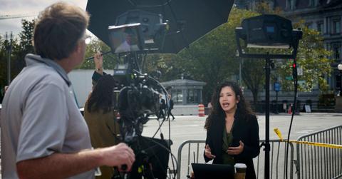 Photo of a reporter delivering a news report