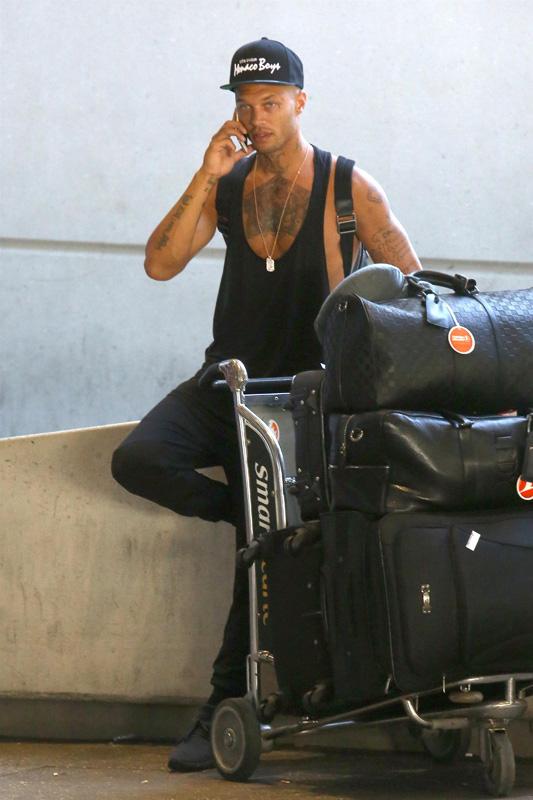 Jeremy Meeks hauls a huge cart of luggage through LAX