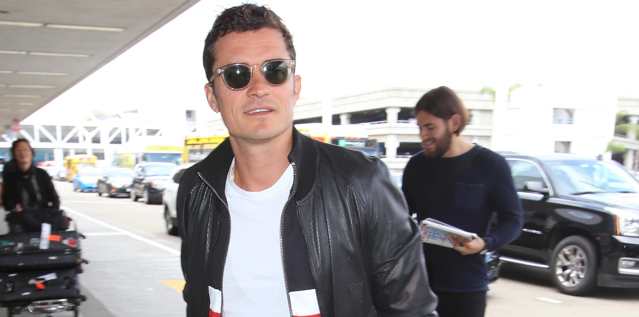 Orlando Bloom signs autographs arriving at LAX