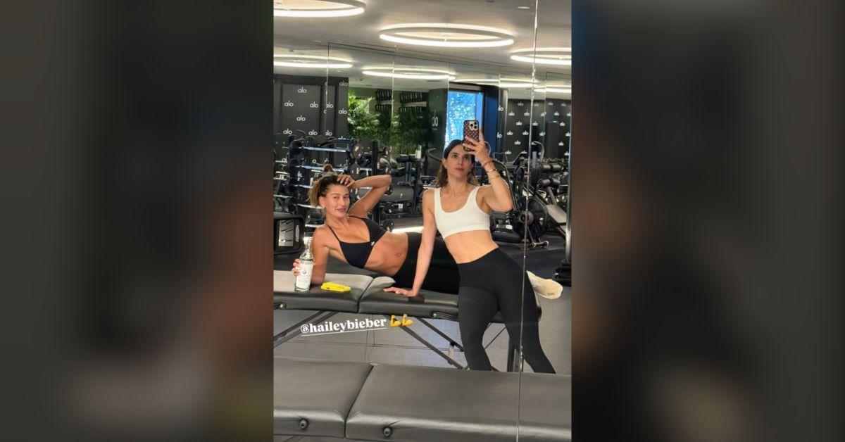 Image of Hailey Bieber stopped for a selfie mid-workout.