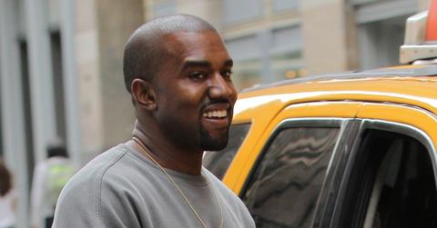 Kanye West happily catches a cab while shopping with a friend in NYC