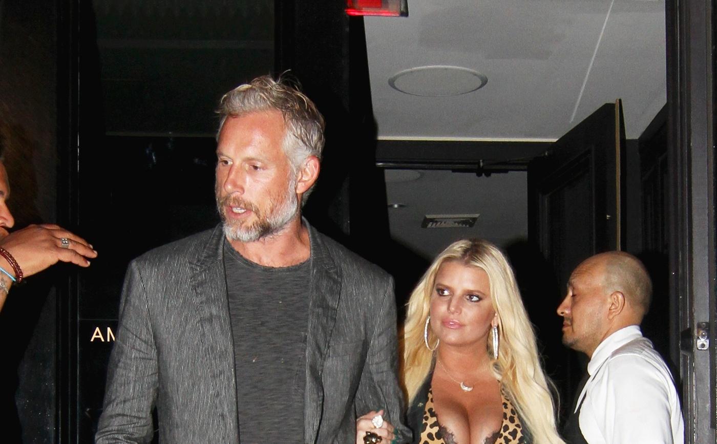 Jessica Simpson cosies up to her husband Eric Johnson in New York