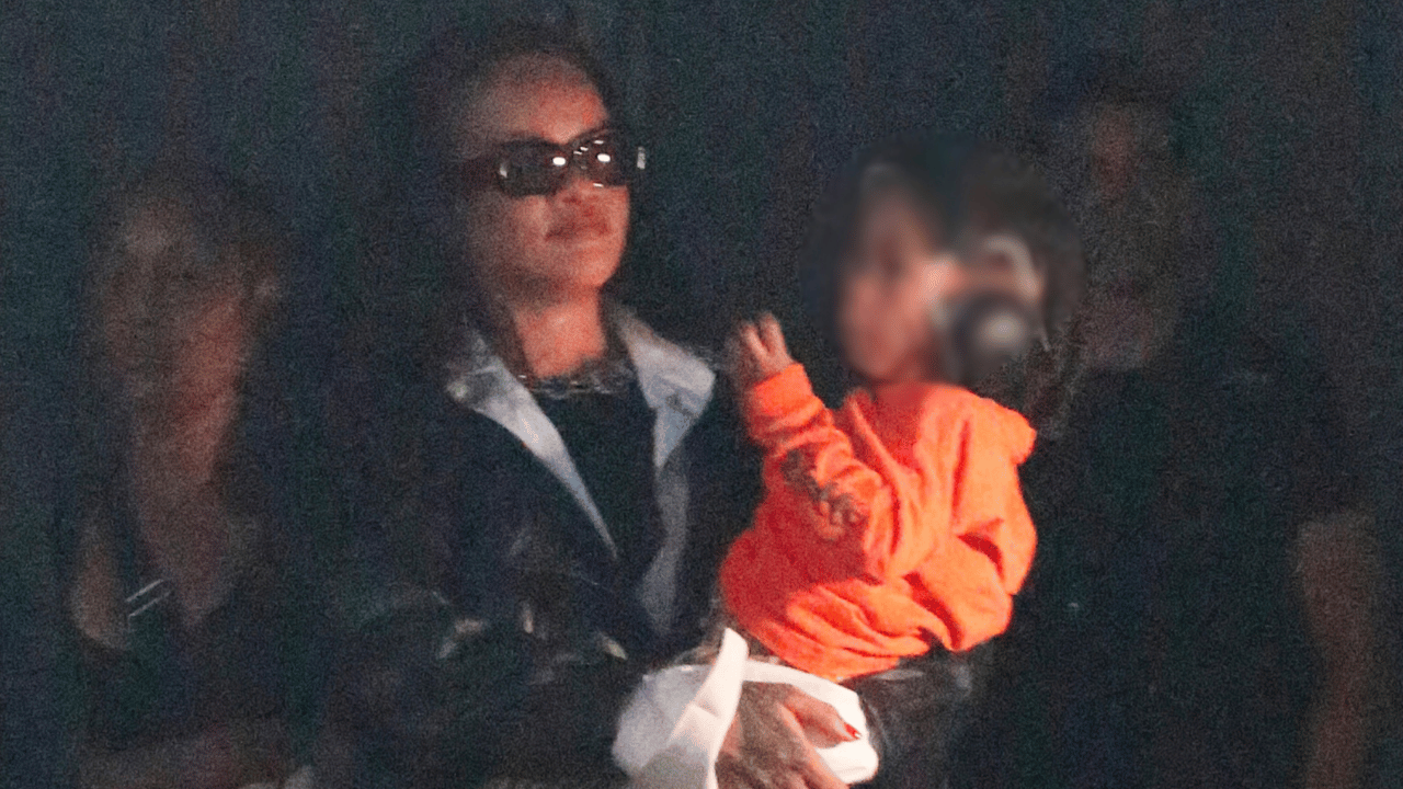 Image of Rihanna held one of her young sons close as the family watched A$AP Rocky perform in Paris.