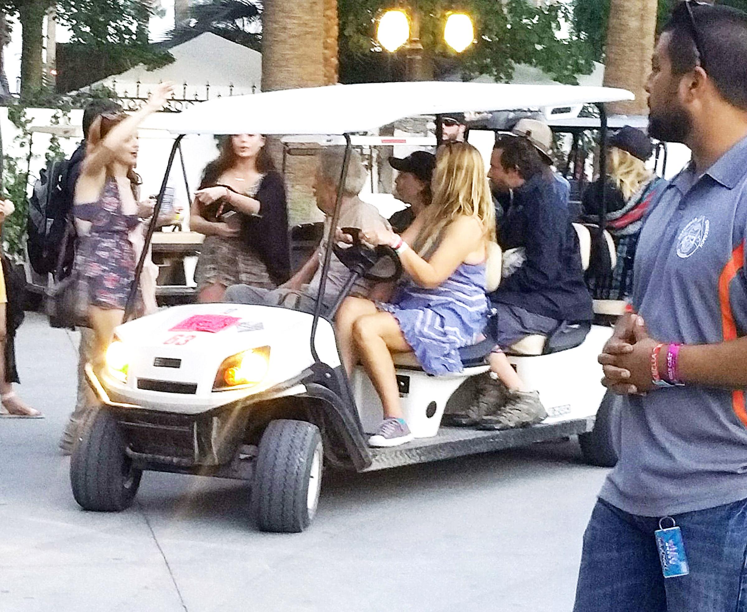 Bradley Cooper and Suki Waterhouse hitch a ride on Clint Eastwood&#8217;s golf cart at Coachella in Indio, CA.