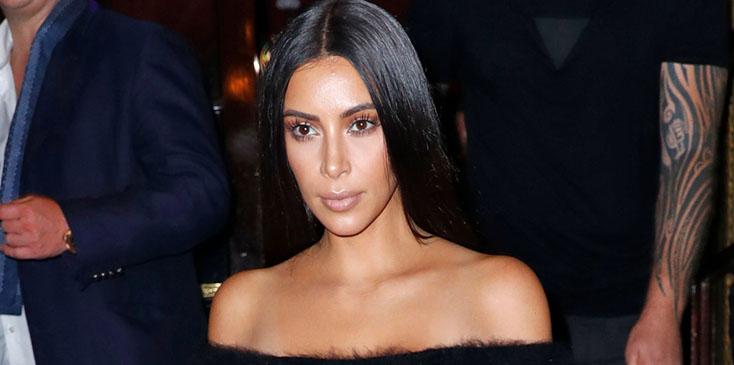 Kim Kardashian bears her shoulders and midriff when coming down the stairs of the Hotel Cortes in Paris