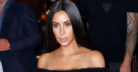 Kim Kardashian bears her shoulders and midriff when coming down the stairs of the Hotel Cortes in Paris