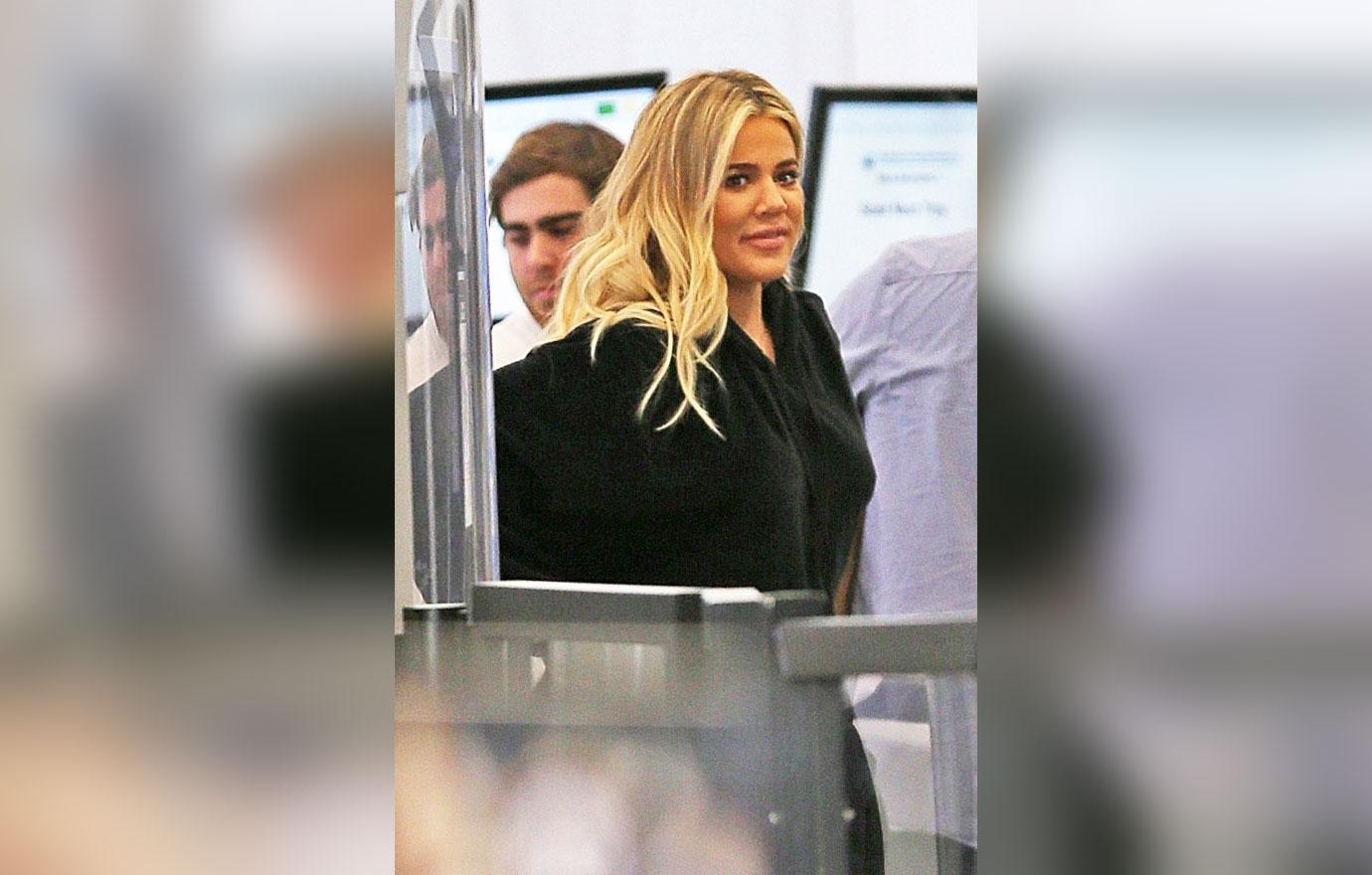 Khloe Kardashian hides her baby bump as she departs LAX