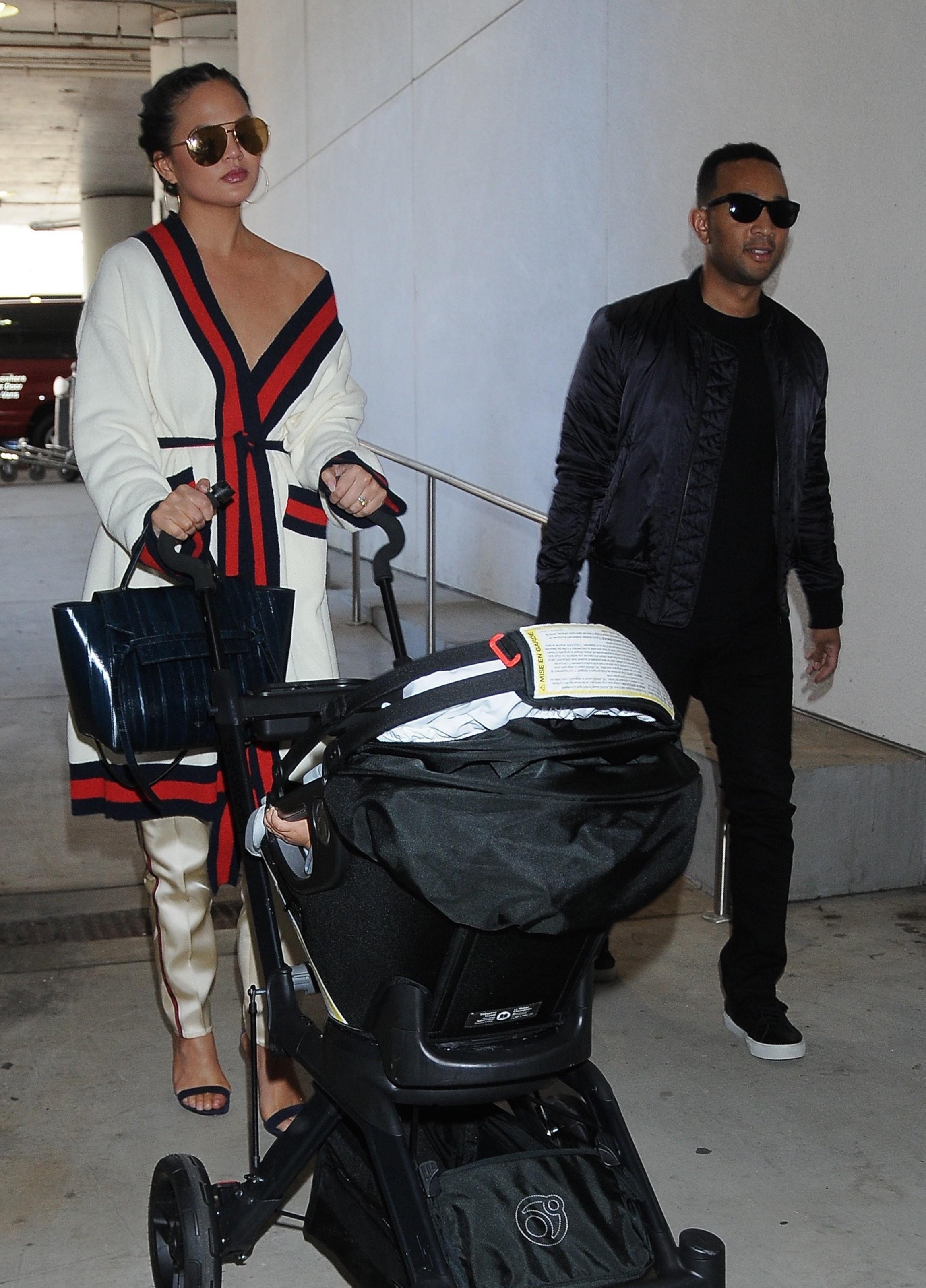 John Legend and Chrissy Teigen depart LAX with Luna